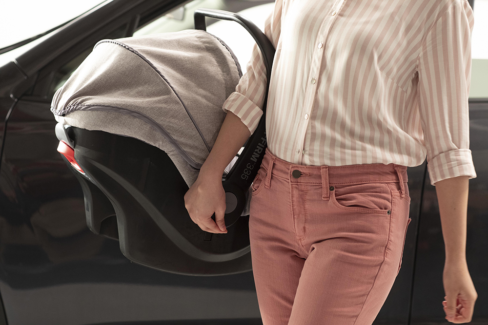 Woman carrying car seat
